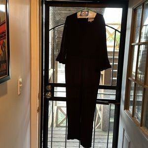 Like new, black jumpsuit with v-neck, crepe material. 3/4 length sleeve w/ruffle
